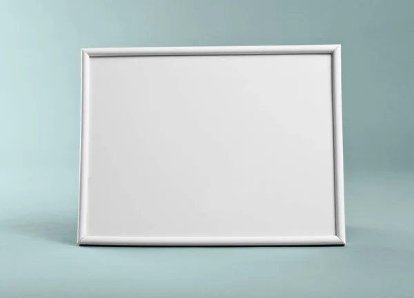 White frame for paintings or photographs on green background. — Stock Photo, Image