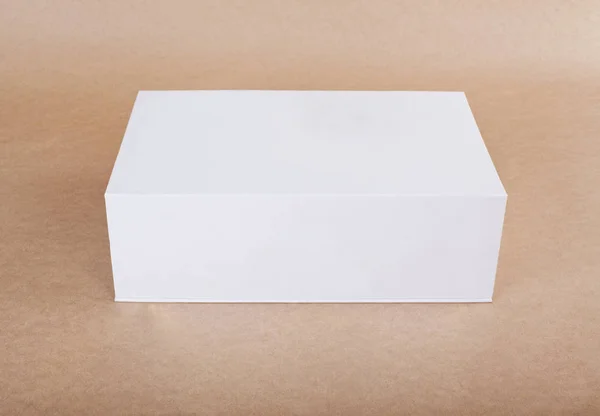 Close up of a white box template on beige background. — Stock Photo, Image