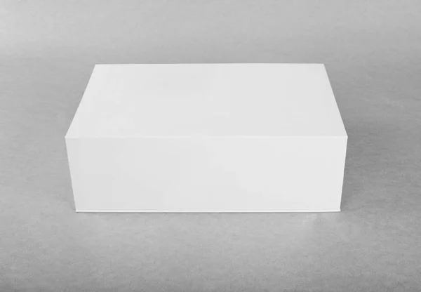 Close up of a white box template on grey background. — Stock Photo, Image