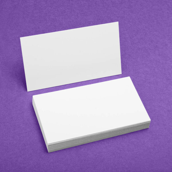 Blank business cards on purple background.