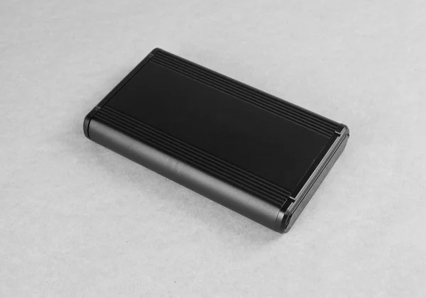 Top view of external computer hard disk drive on gray background — Stock Photo, Image