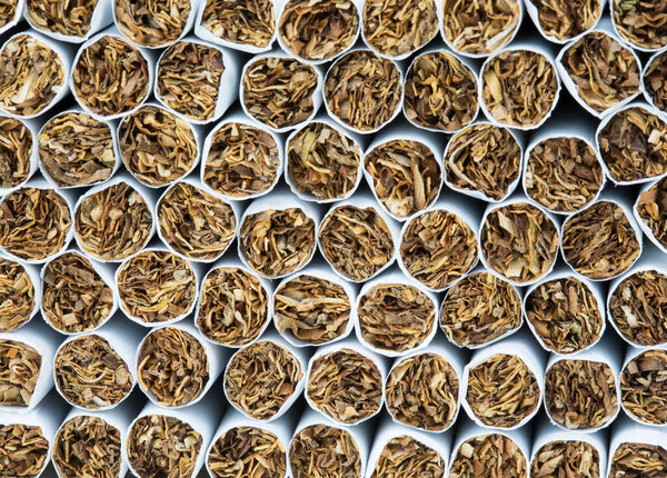 Stack of cigarettes close up as background