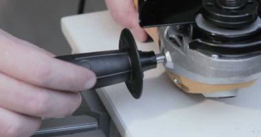 İşçi bir açı öğütücü kolu yükler