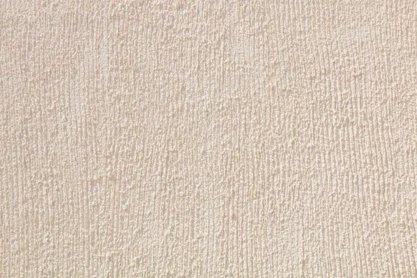 Cream colored rough scratched concrete wall — Stock Photo, Image