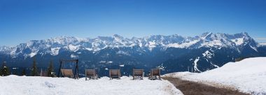 sunbeds at wank mountain with lookout to zugspitze area clipart