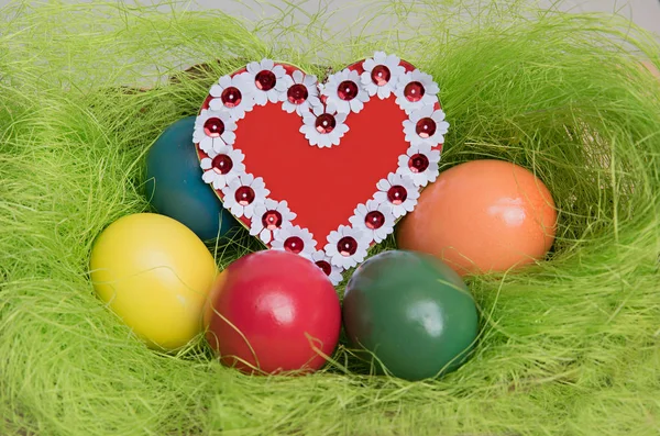 Easter nest with colorful eggs floral heart — Stock Photo, Image