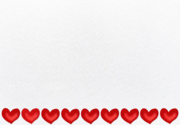 White textile background with a border of red valentine hearts — 스톡 사진