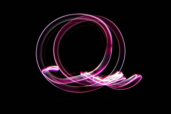 lightpainting effect at night, white and purple colored circle,