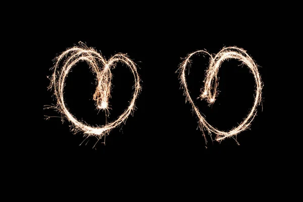 Two glowing hearts. light painting at night with a sparkler. mad — Stock Photo, Image