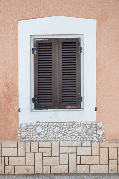 Okno Zavřenými Hnědými Okenicemi Bílým Rámem Výzdobou Skořepin Středomořská Fasáda — Stock fotografie