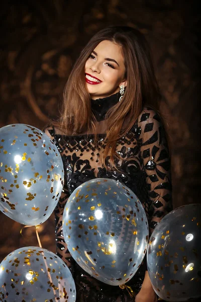 Donna attraente in possesso di palloncini e sorridente, concetto di festa e di stagione delle vacanze — Foto Stock