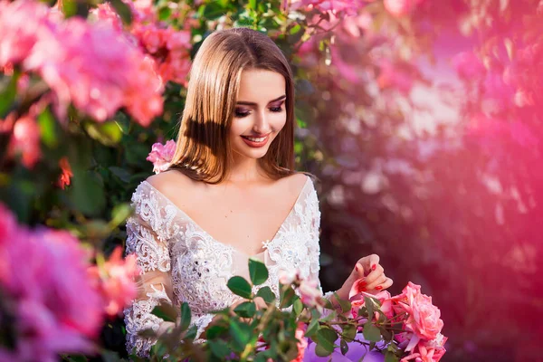 美しい女の子はカラフルな花の近くにポーズエレガントなドレスを着て。ロマンチックな女の芸術作品 . — ストック写真