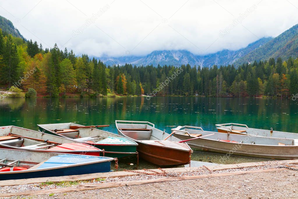 Beautiful Lago di Fusine the mountain lake at boat and Mangart m