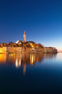 Sunset at medieval town of Rovinj, colorful with houses and chur clipart