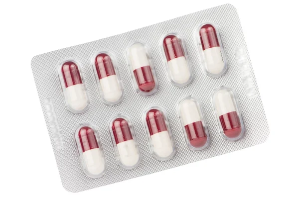 Gesloten van bruine en witte capsules onder blister — Stockfoto