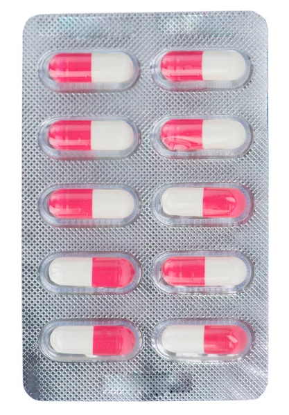 Roze en witte capsule onder blister — Stockfoto