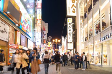 Osaka, Japonya -10 Kasım 2018: Dotonburi, Osaka 'da yürüyen insanların uzun zaman fotoğrafı. Dotonburi, Japonya 'nın Osaka kentindeki turistlerin en ünlü mekanıdır..