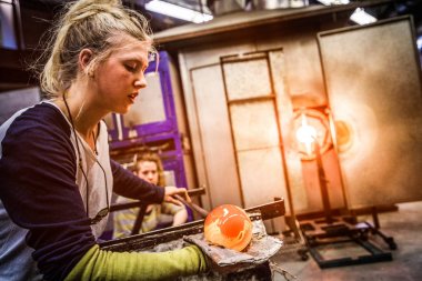 Glass Blowing Workshop - Two Women Shaping glass on the Blowpipe clipart