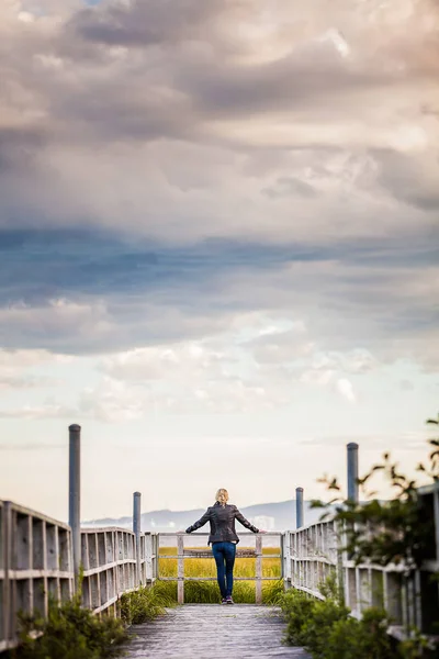 Frau blickt von einem Balkon auf die atemberaubende Landschaft — Stockfoto