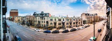 Montreal, Canada - December 3, 2017: Sherbrooke Street 180 degrees Panorama. Facing South, St-Denis is the next Perpendicular Street on the Left. Victorian-Style Offices are visible in front. clipart
