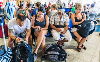 SAN ANDRES ISLAND, Colombia - Circa March 2017: Few People With Tablets and Phones in the Waiting Room at the San Andres Airport. clipart