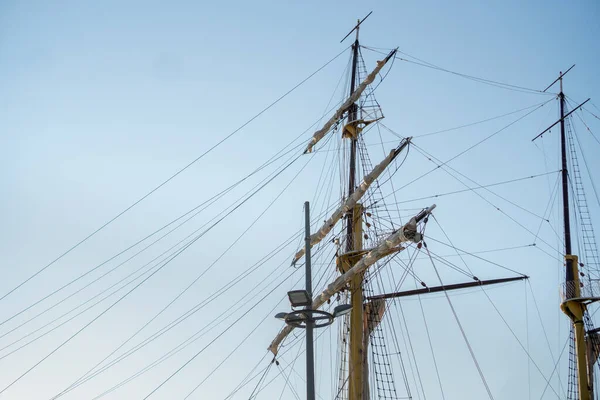 Masts of a vintage yacht with sails