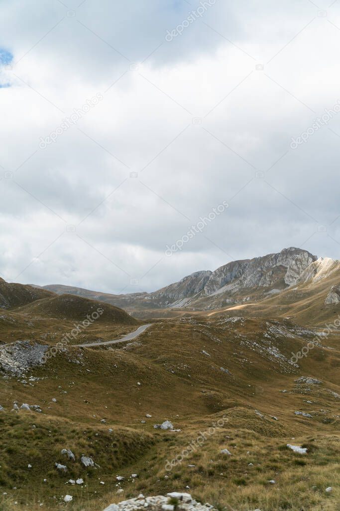 Scenic view of the mountains. Mountain road meanders between the hills. Background