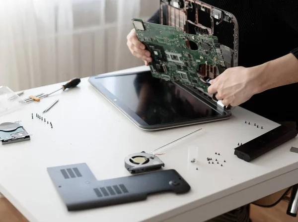 Laptop repair. Disassembled computer parts. PC electronic components. Closeup of keyboard, hdd, motherboard cpu