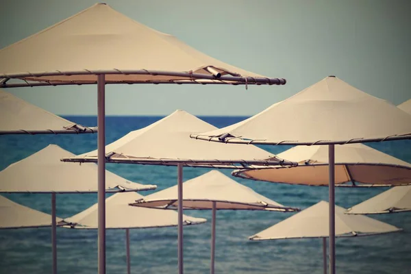 Solar umbrellas closeup on the beach — Stock Photo, Image