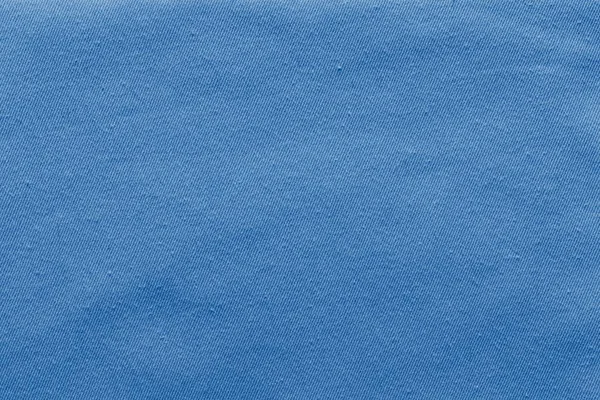 Texturerat bakgrund av denim tyg blek blå färg — Stockfoto