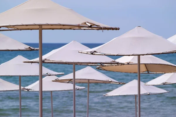 Solar umbrellas closeup on the beach — Stock Photo, Image