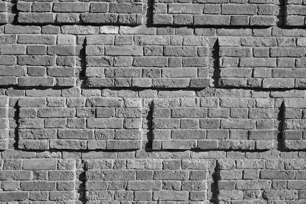 Fondo y textura de una pared de ladrillo tono monocromo —  Fotos de Stock