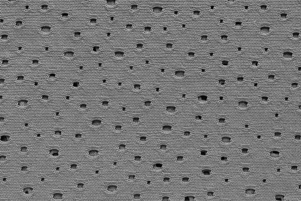 Abstract knitted textile texture with holes — Stock Photo, Image