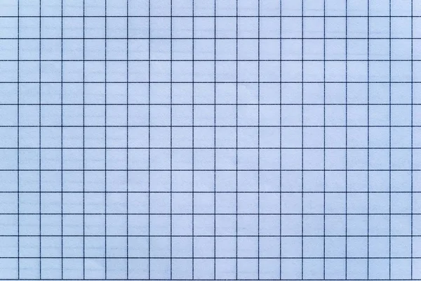 the sheet of checkered paper of a notebook for arithmetics and for a school background or for wallpaper
