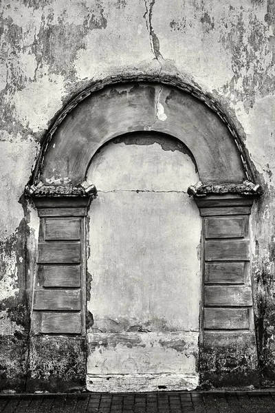 imitation an abstract ancient shape of the arch on an old plastered wall closeup for a vintage frame or for a background of monochrome tone