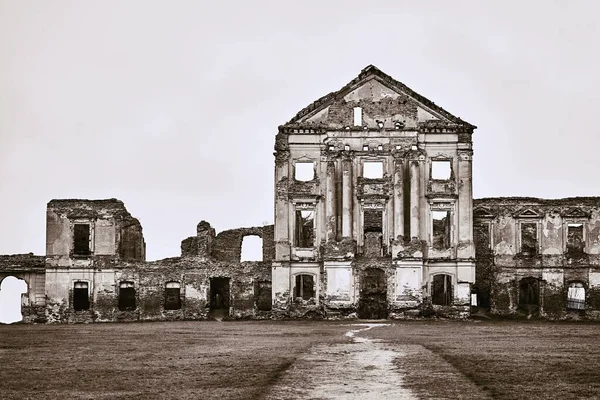 ancient ruins of a ruined old brick building or castle against an empty and clear sky of monochrome tone