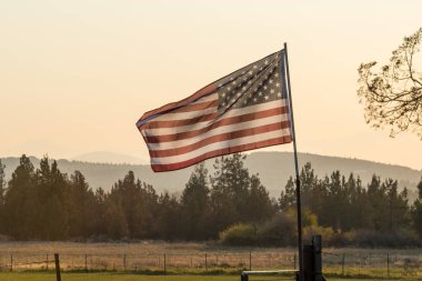 Gün batımı ışığı Terrebonne yakınlarındaki bir Amerikan bayrağından geçer.