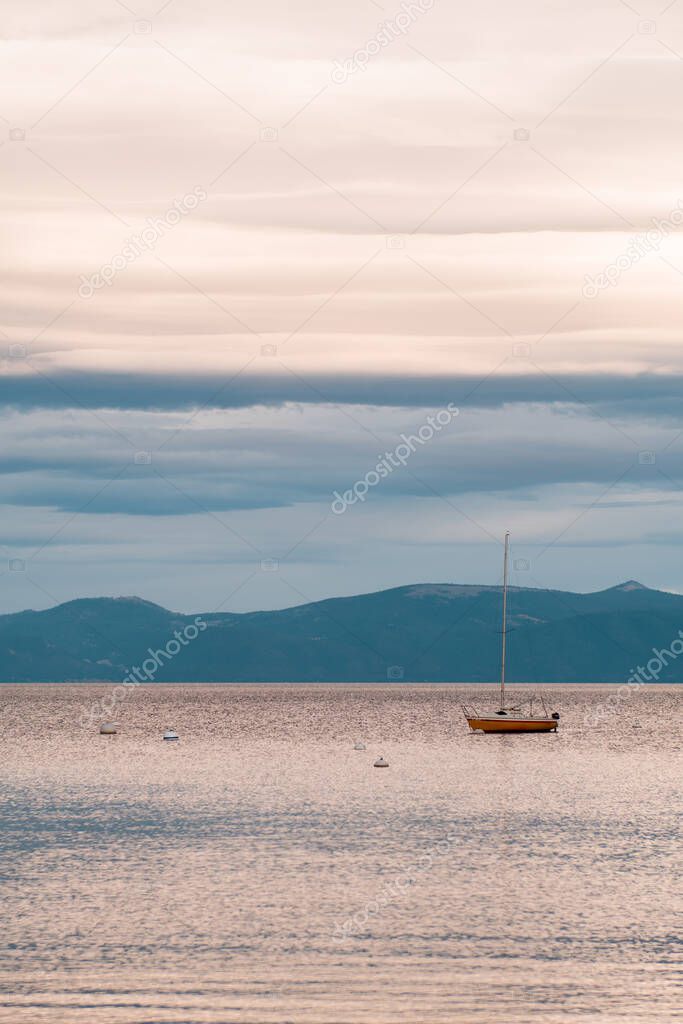 Sunset view of a sailboat and the mountains in Lake Tahoe, Homewood