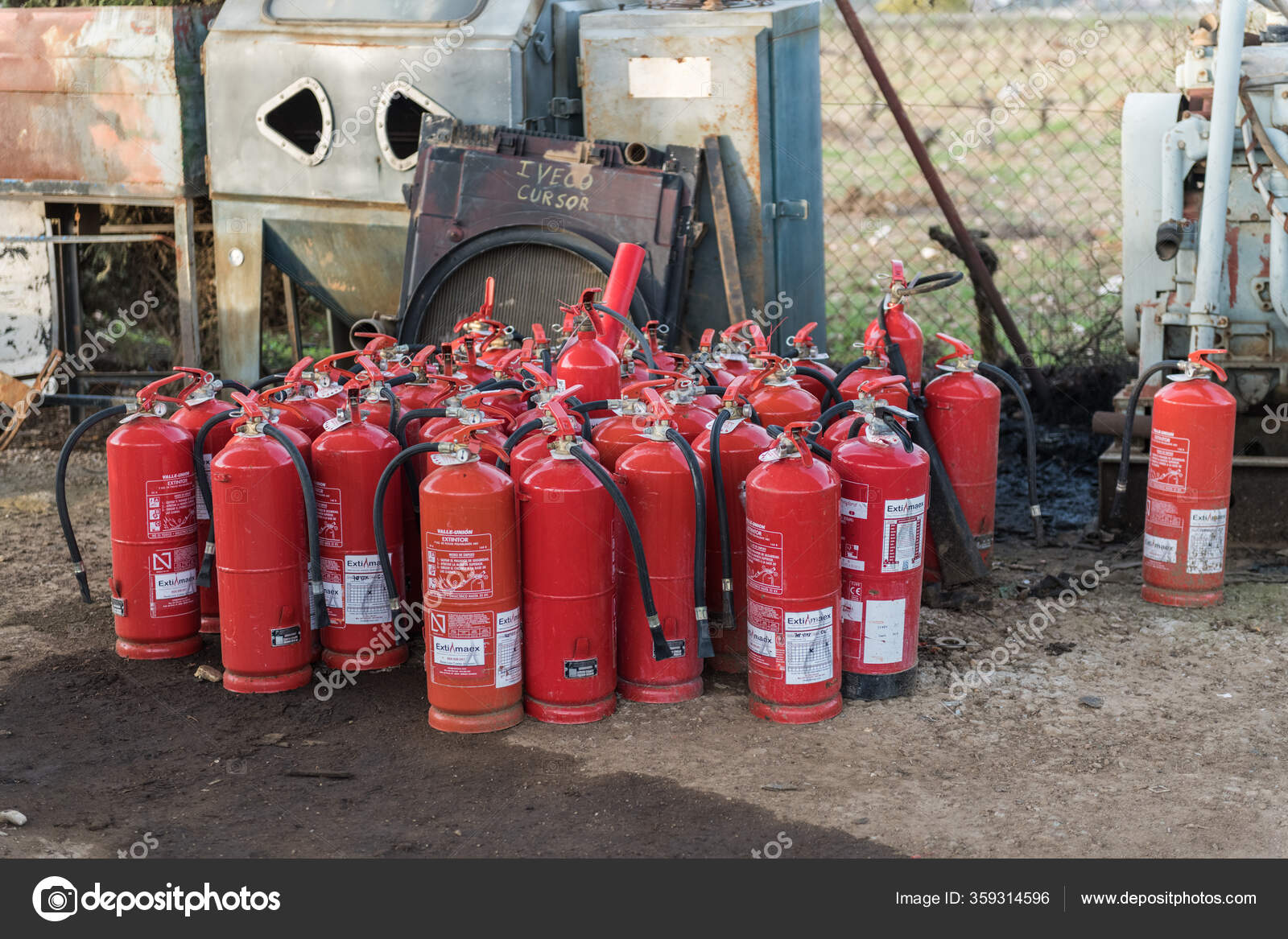 Many empty fire extinguishers accumulated in a junkyard Stock
