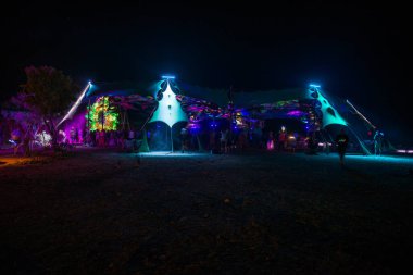 Festivalin sahnesinde insanlar dans ediyor. Psytrance Lost Theory, Rio Malo de Abajo, Las Hurdes 'de.