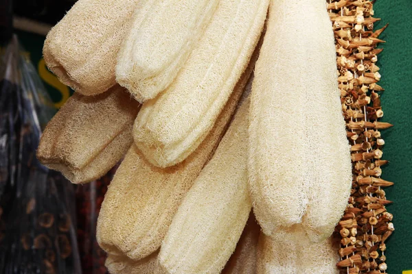Yellow long washcloth for body wash from a natural plant luffa — Stock Photo, Image