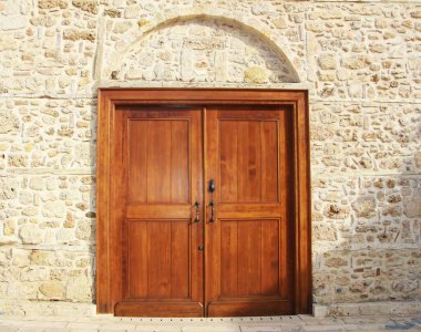 wooden swinging doors in the building with decorative patterns and accessories for opening