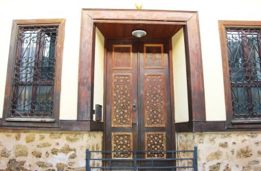 wooden swinging doors in the building with decorative patterns and accessories for opening