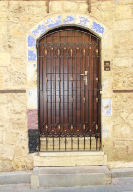 wooden swinging doors in the building with decorative patterns and accessories for opening