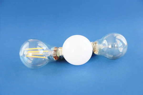 glass light bulbs for lighting on blue background