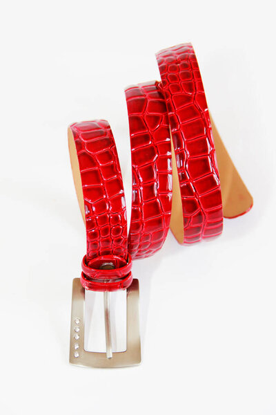 red women's crocodile leather belt with metal buckle on a white background