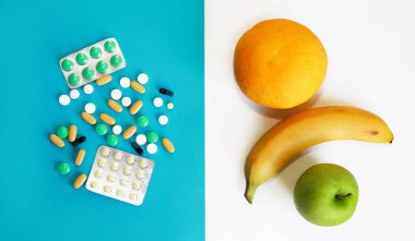 ilaç tabletleri ve meyveler, portakal, greyfurt, elma bir muz