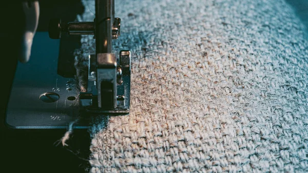 A Sewing Machine Sews Burlap Fabric. Sewing Hemp Fabric Clothing. Close-Up Macro Shot. Sewing Still Life. High Quality Photo