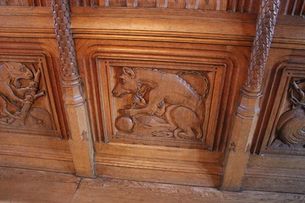 Bojnice, Slovakia - October 04, 2014: Carving fictional and real stories in wooden decoration of the castle interior
