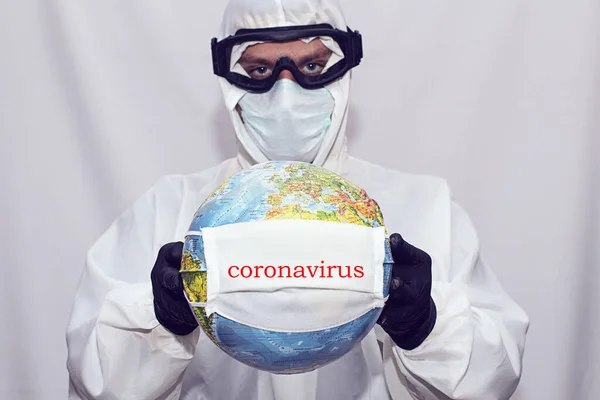 Global Coronavirus Pandemic. A World Globe With A Medical Mask. The man in the medical mask